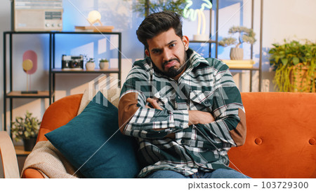 Confused indian man feeling embarrassed about ambiguous question, having doubts, no idea, no answer Confused indian man feeling embarrassed about ambiguous question, having doubts, no idea, no answer 103729300