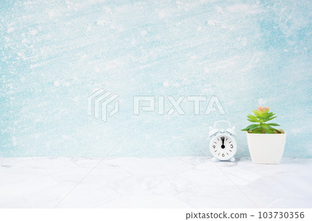 The Alarm clock and plant pot on blue wooden floor with copy space for your design. 103730356