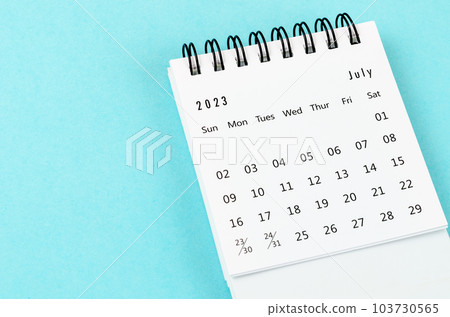 The July 2023 Monthly desk calendar for 2023 year on blue background. 103730565