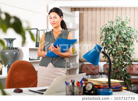 Asian business woman standing in her office Asian business woman standing in her office 103732739