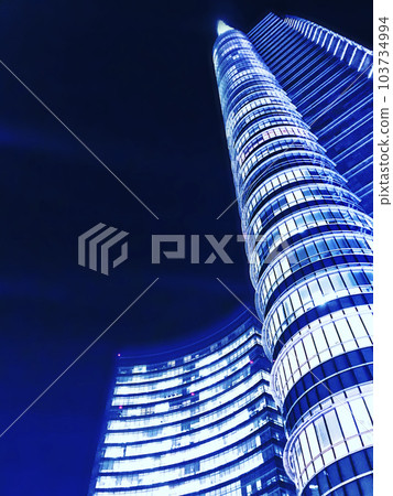 Anime background style, retouched illustration of a futuristic cylindrical skyscraper towering blue on a black background. 103734994