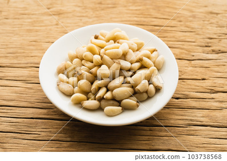 Pine nuts on a small plate (natural taste) 103738568