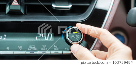 Woman hand adjusting temperature the air flowing during driving car on the road, air conditioner cooling system inside the car. Adjust, temperature and transport concept Woman hand adjusting temperature the air flowing during driving car on the road, air conditioner cooling system inside the car. Adjust, temperature and transport concept 103739494