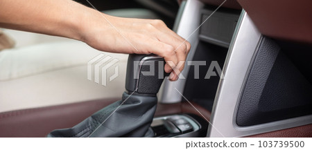woman driver stick shift transmission a car gear, hand controlling steering wheel during vehicle moving. Journey, trip and safety Transportation concepts 103739500