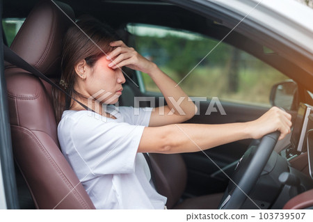 woman feeling stress and angry during drive car long time. Asian girl tired and fatigue having headache stop after driving car in traffic jam. Sleepy, stretching and drunk concept woman feeling stress and angry during drive car long time. Asian girl tired and fatigue having headache stop after driving car in traffic jam. Sleepy, stretching and drunk concept 103739507