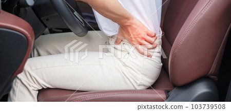 woman with her back sprain while driving car long time, back body ache due to Piriformis Syndrome, Low Back Pain and Spinal Compression. Ergonomic and medical concept woman with her back sprain while driving car long time, back body ache due to Piriformis Syndrome, Low Back Pain and Spinal Compression. Ergonomic and medical concept 103739508