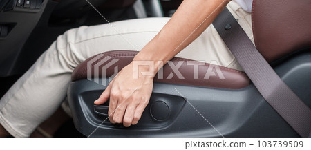 Hand adjust car seat before drive on the road . Ergonomic and safety transportation concept Hand adjust car seat before drive on the road . Ergonomic and safety transportation concept 103739509