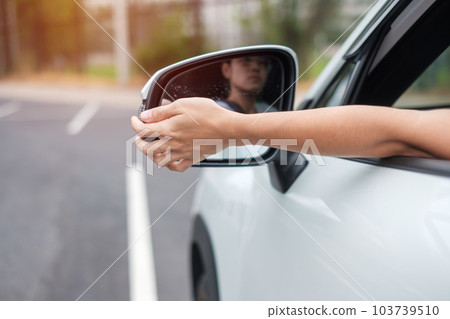 woman driver adjusting side view mirror a car. Journey, trip and safety Transportation concepts woman driver adjusting side view mirror a car. Journey, trip and safety Transportation concepts 103739510