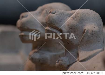 Stone sculpture of two dogs in a close up photo. Marble carvings in a cathedral. Dogs have intricate detail, collars with bells on. Selective focus Stone sculpture of two dogs in a close up photo. Marble carvings in a cathedral. Dogs have intricate detail, collars with bells on. Selective focus 103740049
