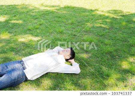 Photo of a man lying on the grass 103741337