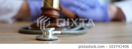 Judge gavel, doctor stethoscope and woman doctor on background 103741406