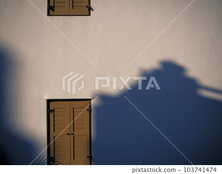 Shadow and light reflected on the white wall Shadow and light reflected on the white wall 103741474