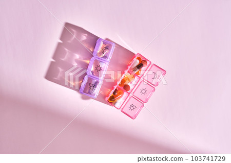 Bright pill box with different pills and vitamins. 103741729