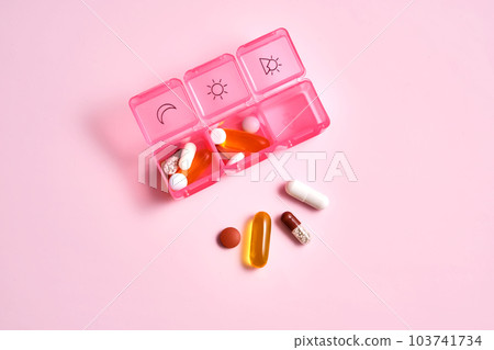 Bright pill box with different pills and vitamins. 103741734