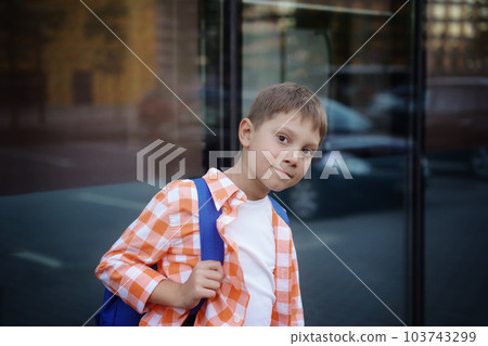 caucasian boy walking from school wearing school bag. Begining of academic year caucasian boy walking from school wearing school bag. Begining of academic year 103743299