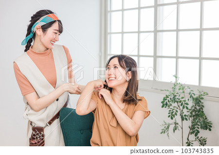 Hairdresser / stylist counseling with Asian female customer who consults hairstyle at beauty salon / hair salon 103743835