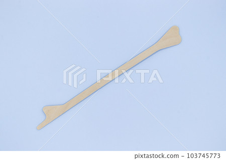 Disposable Wooden spatula on blue background, use for gynecologi Disposable Wooden spatula on blue background, use for gynecologi 103745773
