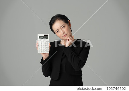 Woman in mourning dress calculator money 103746502