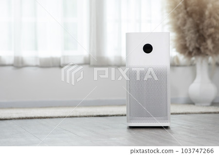 Air purifier in cozy white bedroom for filter and cleaning removing dust PM2.5 HEPA and virus in home,for fresh air and healthy Wellness life.Health care Air Pollution Concept Air purifier in cozy white bedroom for filter and cleaning removing dust PM2.5 HEPA and virus in home,for fresh air and healthy Wellness life.Health care Air Pollution Concept 103747266