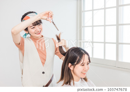 A woman who came to a beauty salon and a hairdresser/barber who cuts hair A woman who came to a beauty salon and a hairdresser/barber who cuts hair 103747678