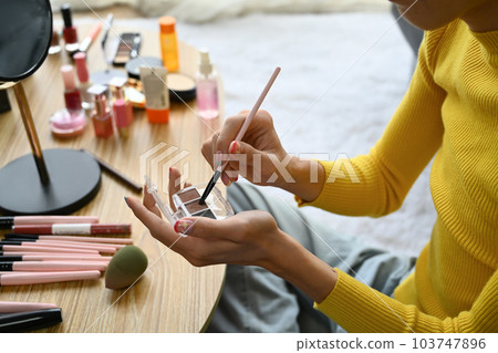 Smiling Asian gay man blogger filming daily makeup routine tutorial on smartphone. LGBTQ, domestic life and beauty concept Smiling Asian gay man blogger filming daily makeup routine tutorial on smartphone. LGBTQ, domestic life and beauty concept 103747896