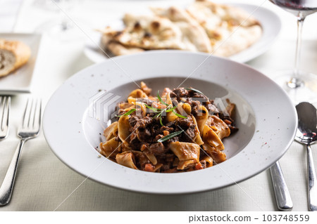 Papardelle al cinghiale, a Sienese typical dish with game ragout in a plate 103748559