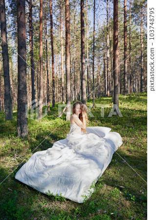 Woman sleeps on a mattress in the summer forest 103748795
