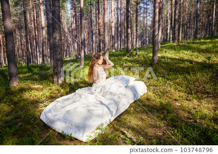 Woman sleeps on a mattress in the summer forest Woman sleeps on a mattress in the summer forest 103748796