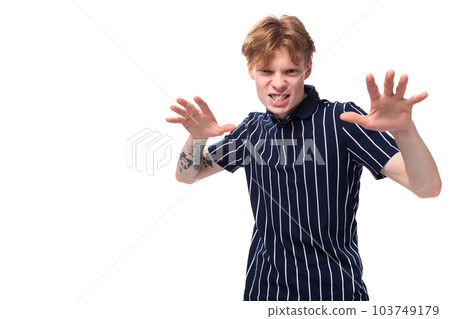 emotional 25s blond man with tattoos grimacing 103749179