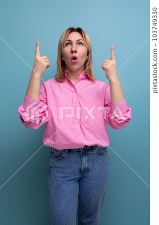 young smart blond european office worker lady with flowing hair in pink blouse reports idea on 103749330