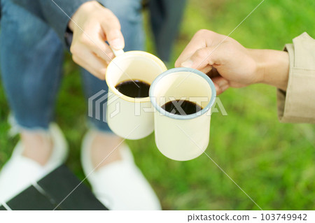 Man and woman drinking coffee at camp 103749942