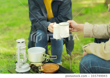 Man and woman drinking coffee at camp 103749943