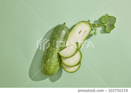 Minimal scene with fresh winter melon placed on pastel background. Winter melon (Benincasa hispida) is low in calories and are ideal for people aiming for weight loss and those with diabetes 103750159