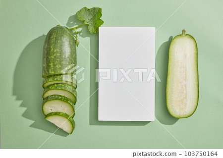 Over a light background, rectangle white podium and winter melon cut in half and slices are arranged. Modern minimal showcase for cosmetic product promotion Over a light background, rectangle white podium and winter melon cut in half and slices are arranged. Modern minimal showcase for cosmetic product promotion 103750164