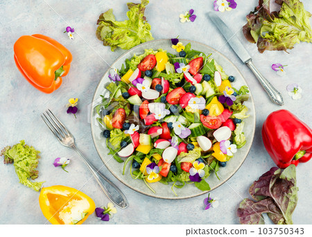Tasty summer salad with edible flowers 103750343