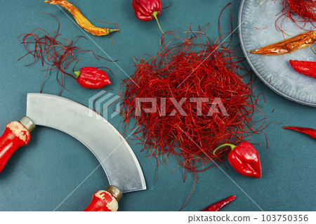 Cutting red chilly peppers. Cutting red chilly peppers. 103750356