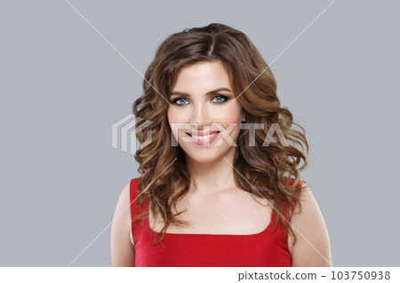 Pretty woman with long perfect curly hair against grey studio wall banner background 103750938