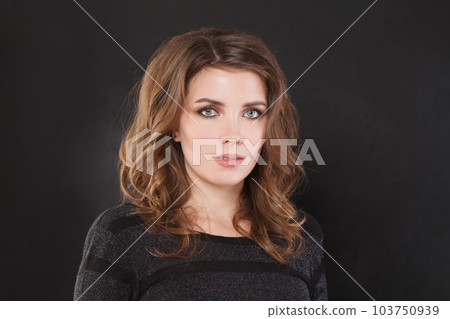 Portrait of nice elegant woman with brown wavy hair and makeup on black background Portrait of nice elegant woman with brown wavy hair and makeup on black background 103750939