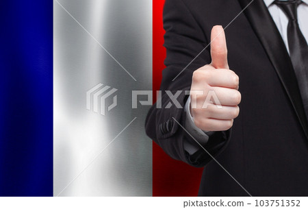 French concept. Businessman showing thumb up on the background of flag of France French concept. Businessman showing thumb up on the background of flag of France 103751352