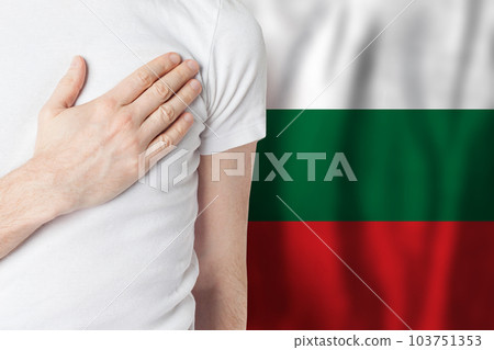 Bulgarian person with hand on heart on the background of Bulgary flag. Patriotism, country 103751353