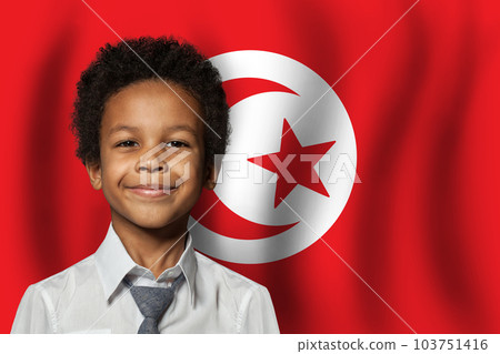 Tunisian kid boy on flag of Tunisia background. Education and childhood concept 103751416
