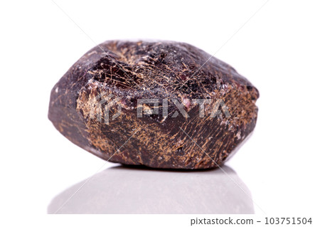 Macro of a mineral garnet stone on a white background Macro of a mineral garnet stone on a white background 103751504