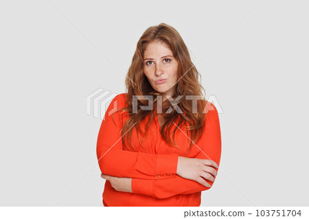 Portrait of redhead woman wearing red shirt on white background 103751704