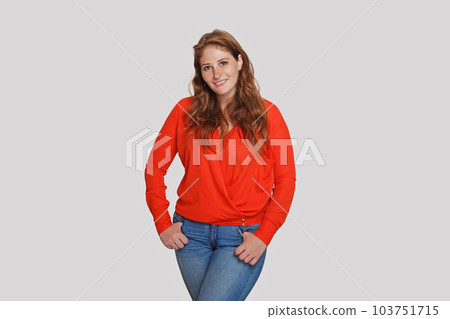 Cheerful woman wearing red shirt standing on white background 103751715