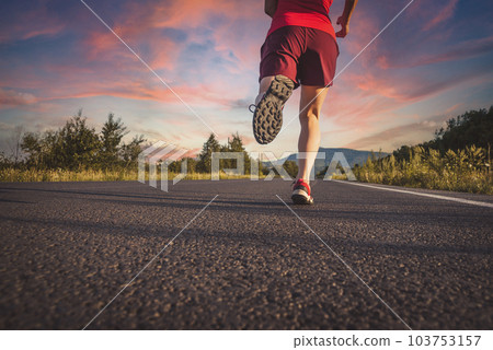Fitness blonde woman running on the asphalt road at the mountains Fitness blonde woman running on the asphalt road at the mountains 103753157