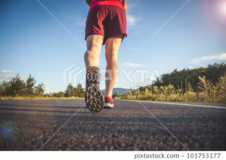 Fitness blonde woman running on the asphalt road at the mountains Fitness blonde woman running on the asphalt road at the mountains 103753177