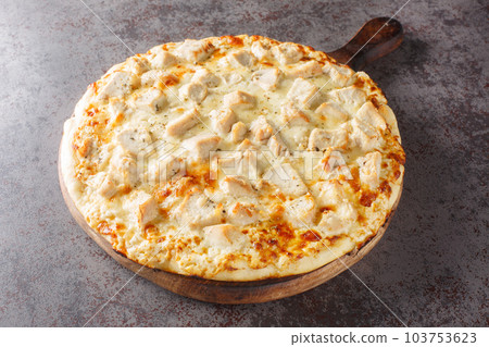 Parmesan Crusted Chicken Alfredo Pizza closeup on the wooden board. Horizontal 103753623