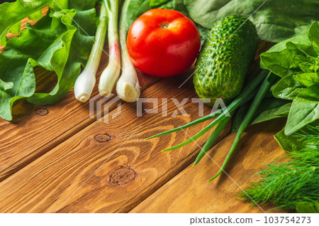 Big set of vegetables for a salad diet on a vintage table. Cooking salad in the restaurant kitchen. Free ad space. 103754273