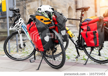 Many modern bicycles with travel luggage bags equipment parked in old european city center street. Healthy eco sustainable tourism family trip lifestyle. Bike hobby adventure tour journey 103755455