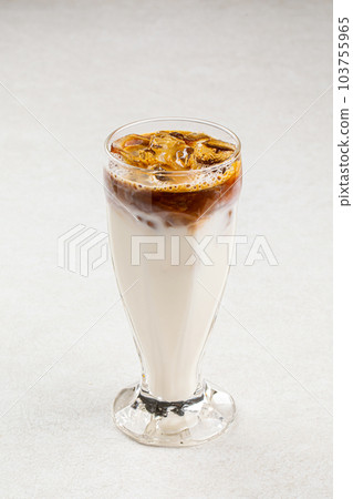 Glass of cold coffee with ice and milk Glass of cold coffee with ice and milk 103755965